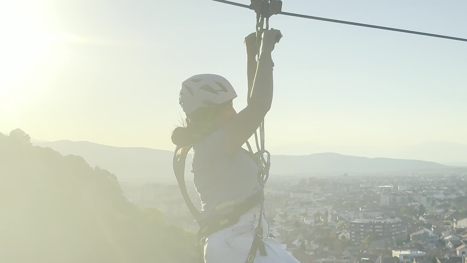 Rider hanging from the line against the evening sun